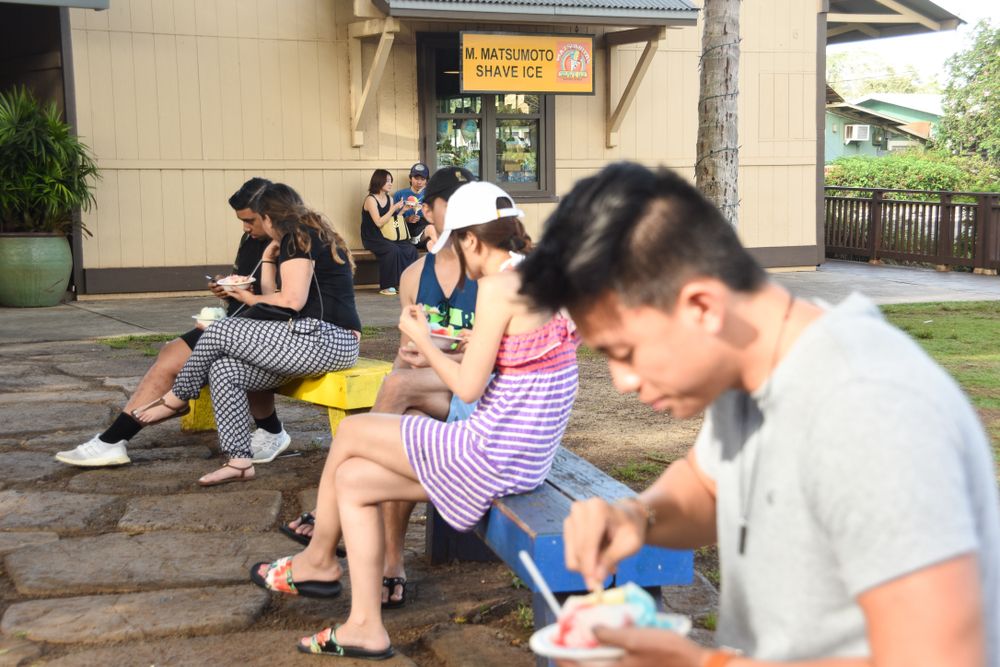 People eating in front of Matsumoto Shave Ice
