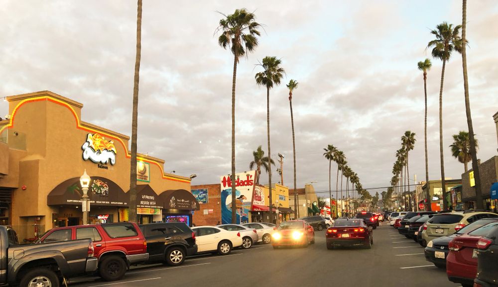 Cars parked along the road of newport avenue.