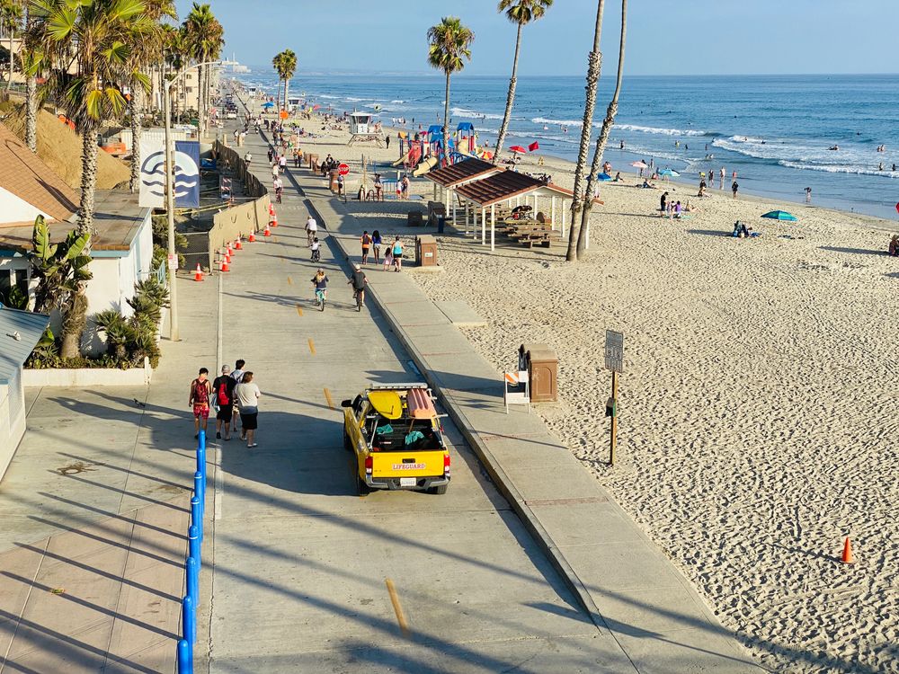 People walking on the sidewalk in Harbor Beach