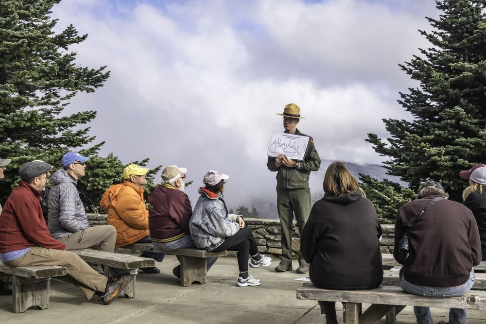 A park ranger discussing Hurricane Ridge weather to tourists