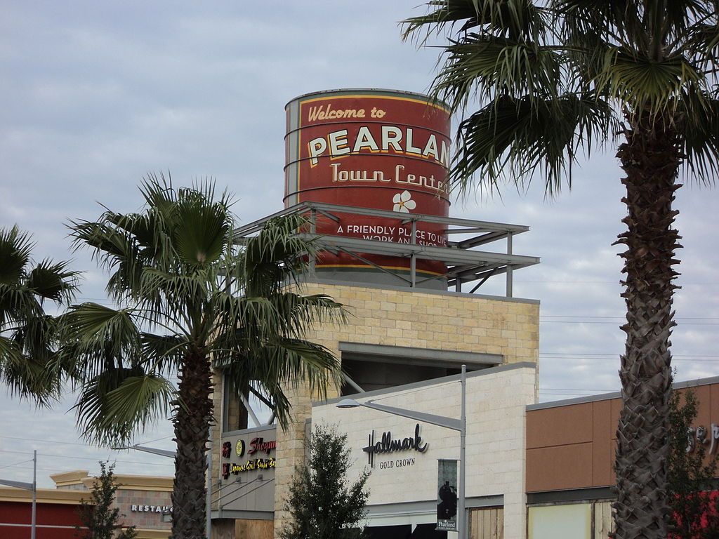 Welcoming sign of the pearland town center on top of a building.