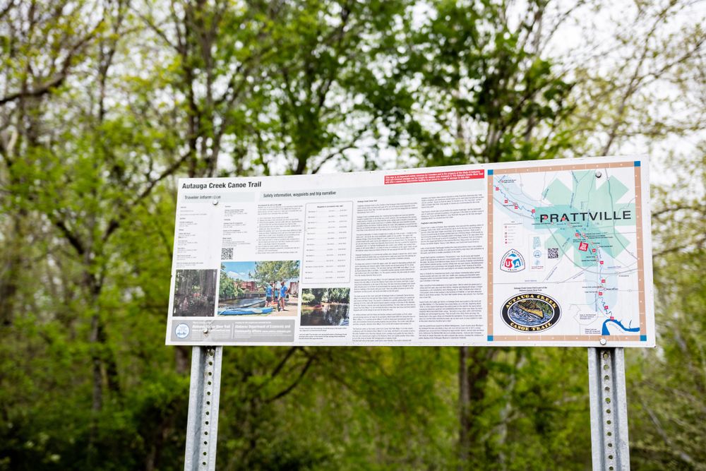 A sign post with Autauga Creek Canoe Trail's map