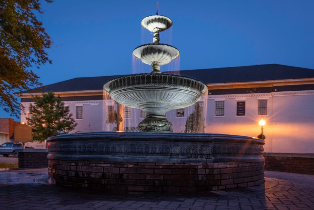 The three-tiered fountain at Heritage Park during the evening