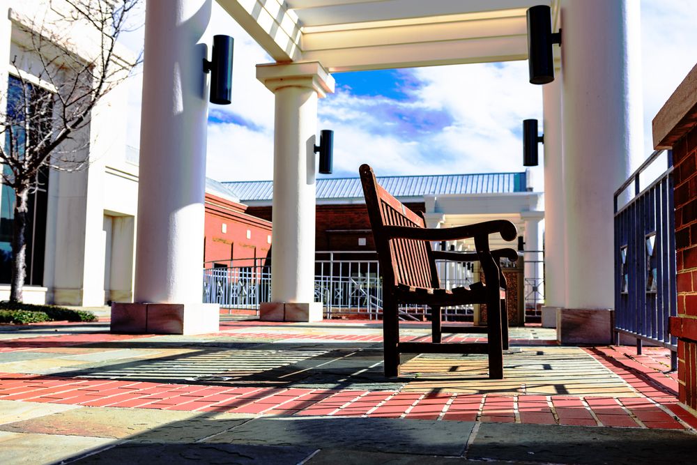 A wooden chair in front of Montgomery Museum of Fine Arts