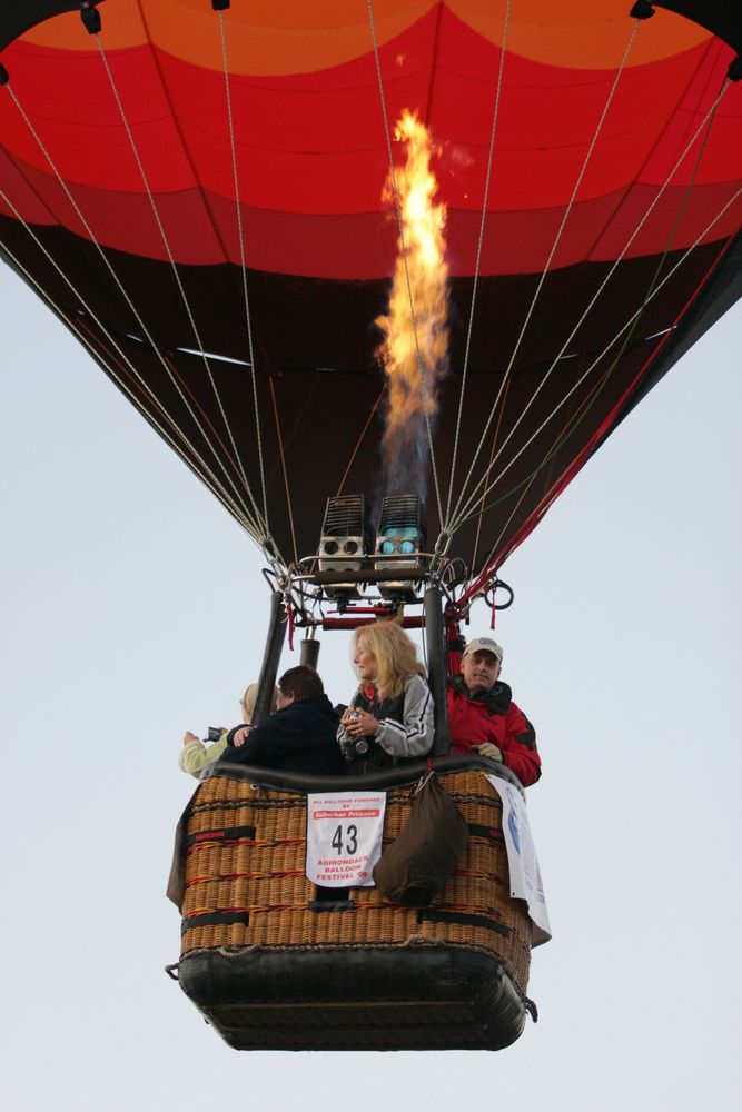 People on a hot air balloon at the Adirondack Balloon Festival