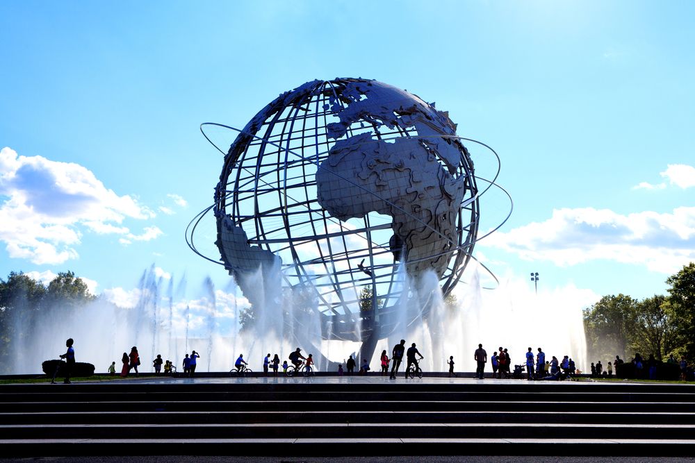 People admiring Flushing Meadows Corona Park's unisphere