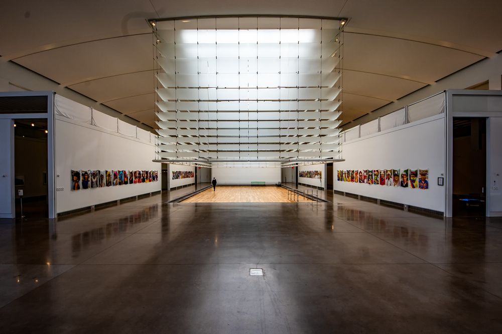 Interior view of Queens Museum with art portraits hanging on the walls.