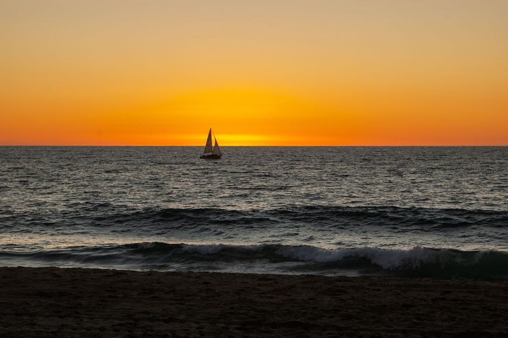 Silhouette of a sailing boat on redondo beach