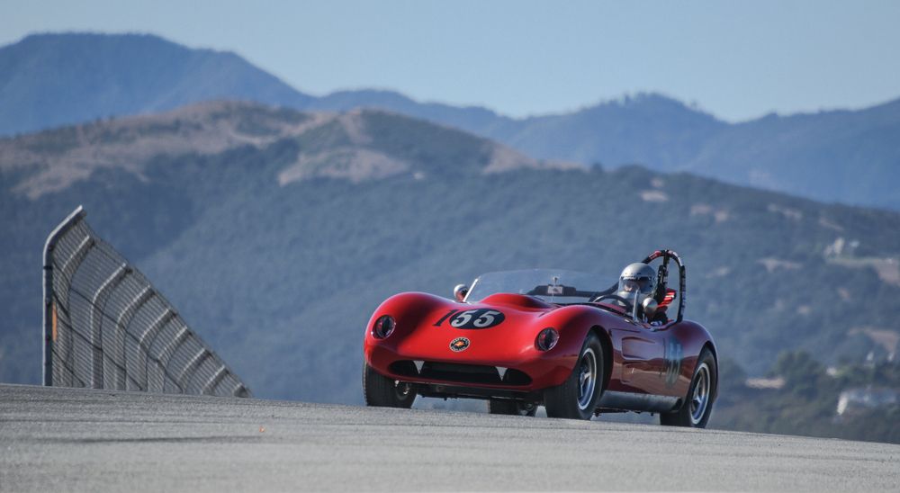 A red colored race car numbered "55" along the raceway.