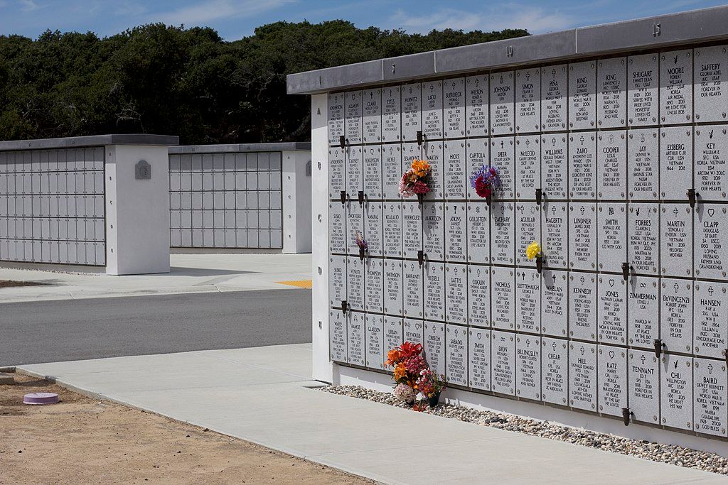 The columbaria with colorful flowers located within the cemetery.