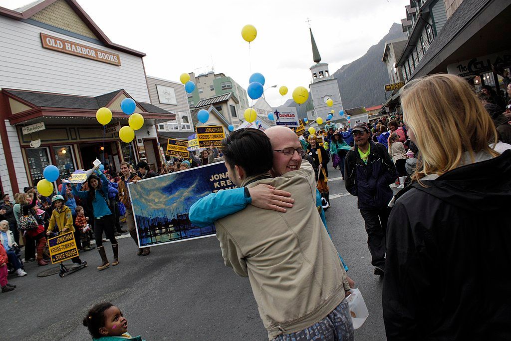 Two people hugging outside the old harbor books building.