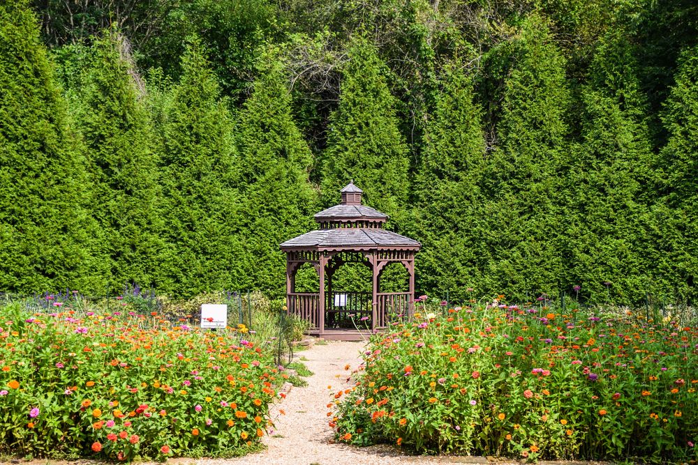 A gazebo surrounded with lush trees and flowers in Nathanael Greene / Close Memorial Park