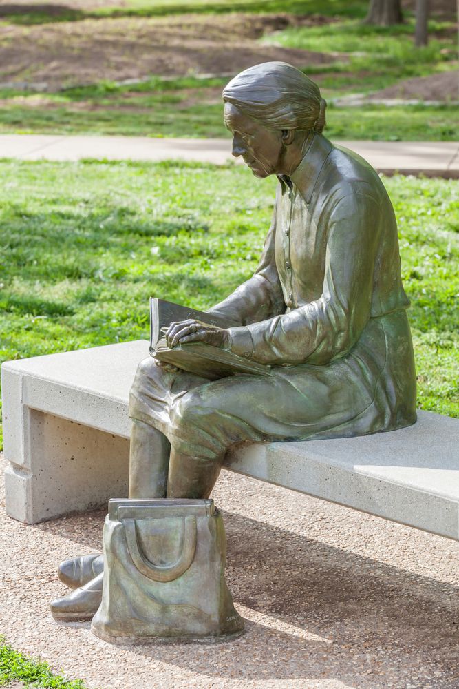 A woman reading a book sculpture in Nathanael Greene / Close Memorial Park