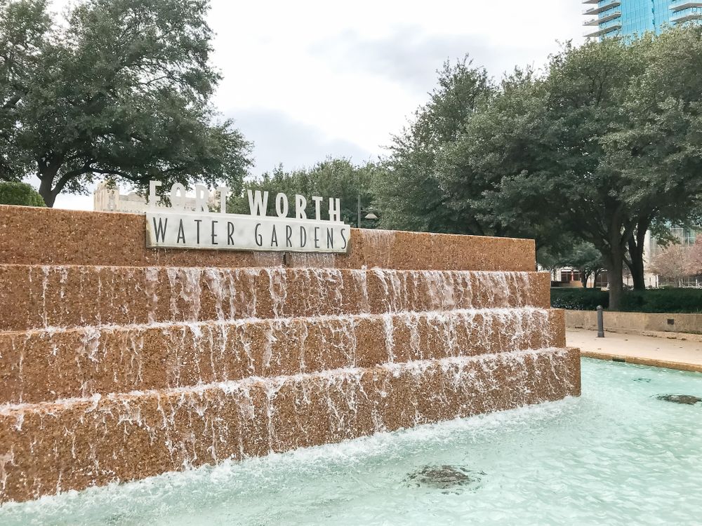 Name sign of Fort Worth Water Gardens on a wall fountain