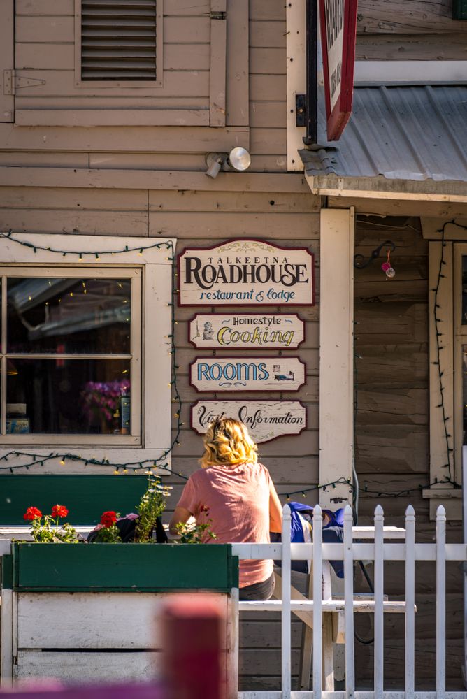 A person at Talkeetna Roadhouse outdoor dining setup