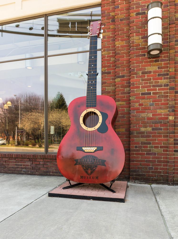 Large guitar sculpture in front of the Birthplace of Country Music Museum