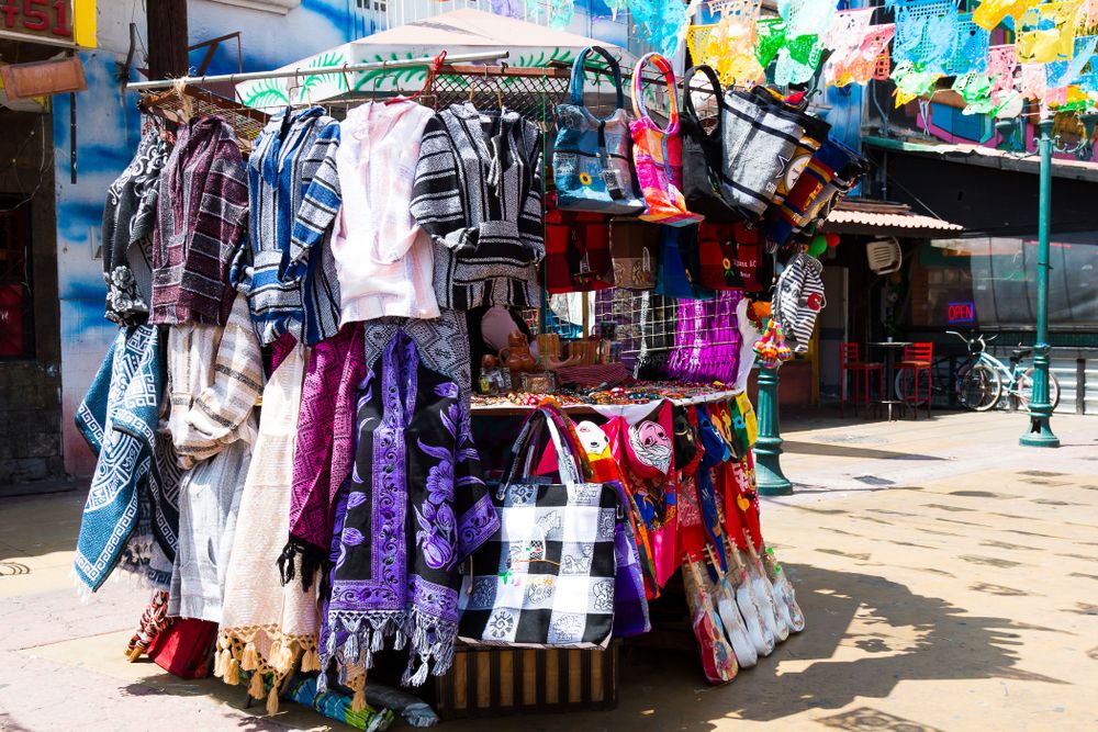 Clothing and bag vendor at Plaza Santa Cecilia
