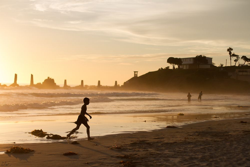 Silhouette of a kid walking along Rosarito Beach