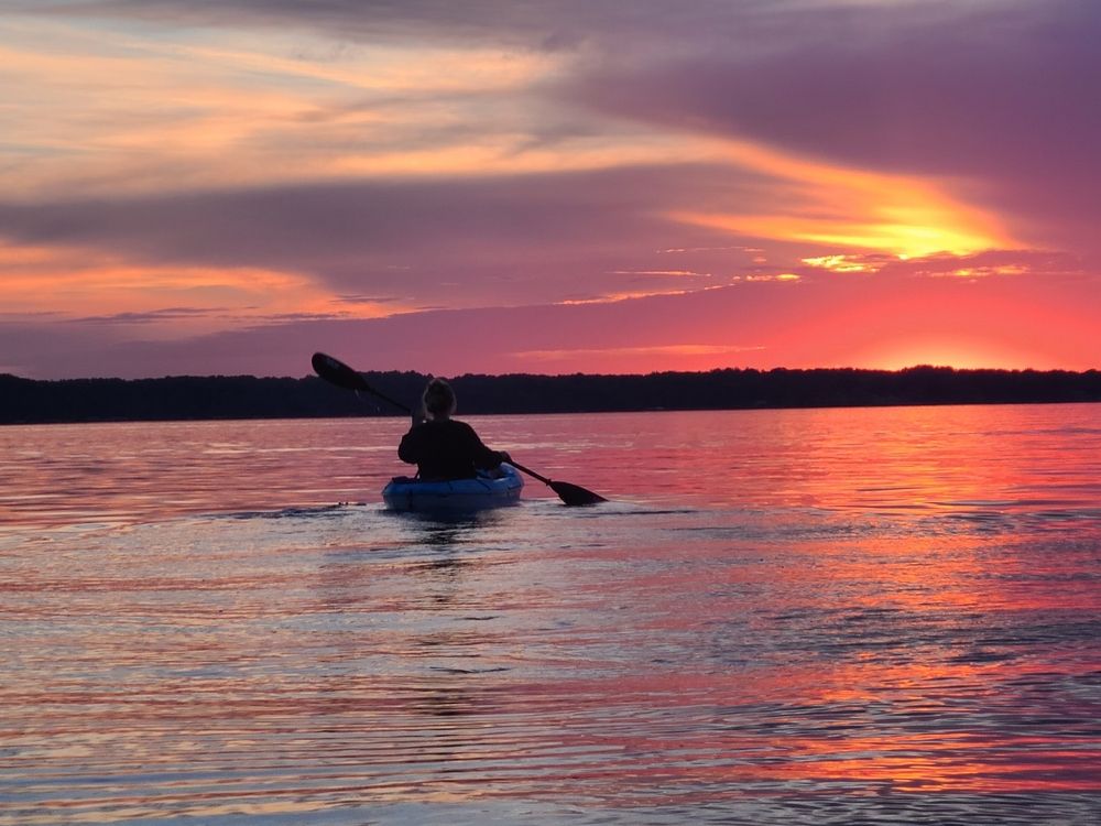 Silhouette of a kayaker on Torch Lake