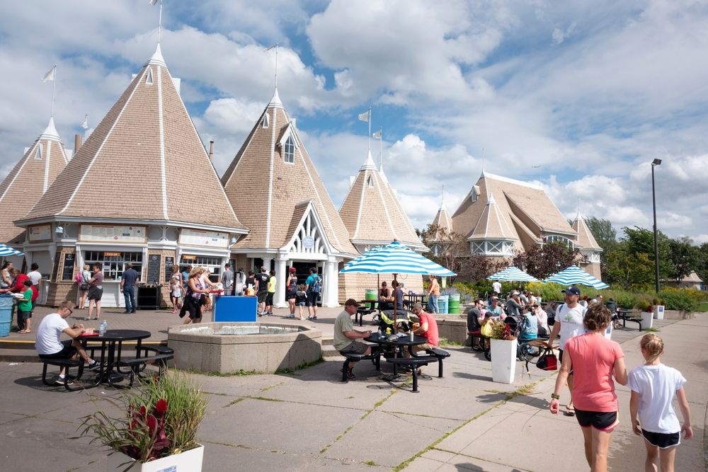 People dining at the bandshell and pavilion area of Lake Harriet Park