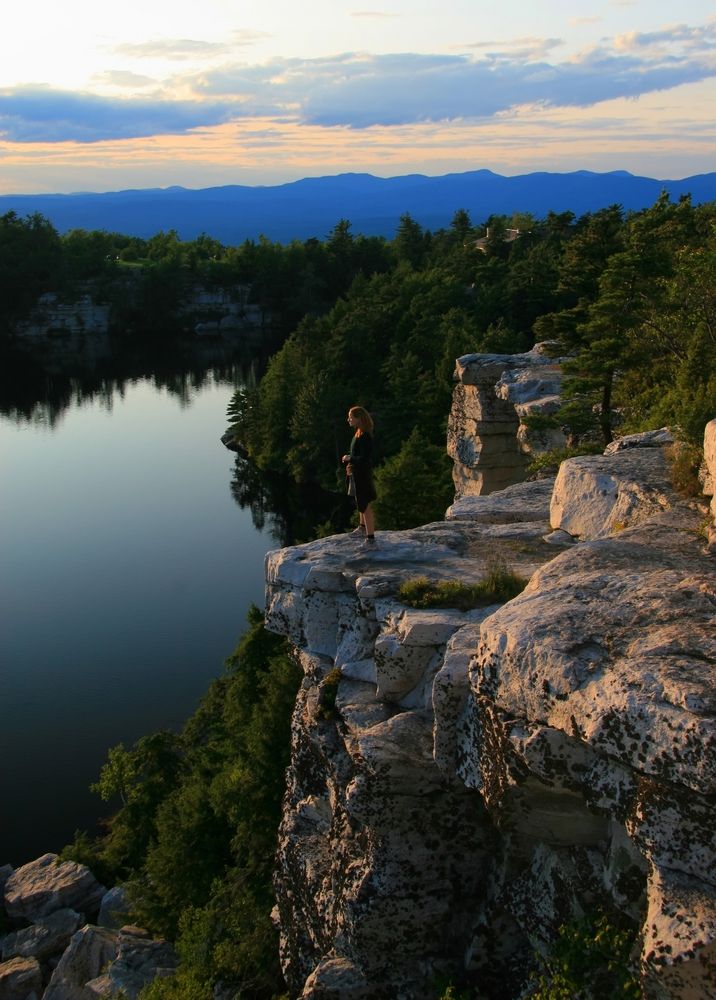 A woman standing on a cliff of Shawangunk Mountains